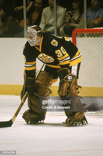 Canadian hockey player Gerry Cheevers, goalkeeper for the Boston Bruins, guards the net during a road game, 1979 or 1980.