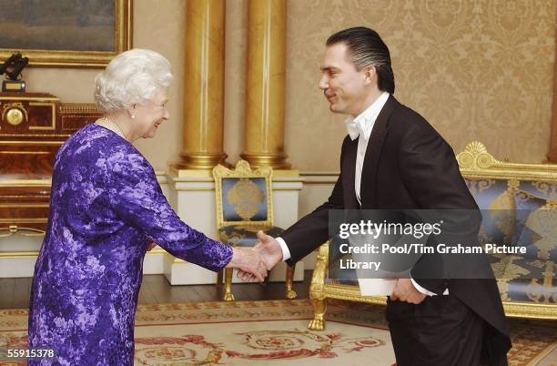 Queen Elizabeth II welcomes the Ambassador of Nicaragua, Mr Piero Paolo Coen Ubilla to Buckingham Palace on October 11, 2005 in London, England.