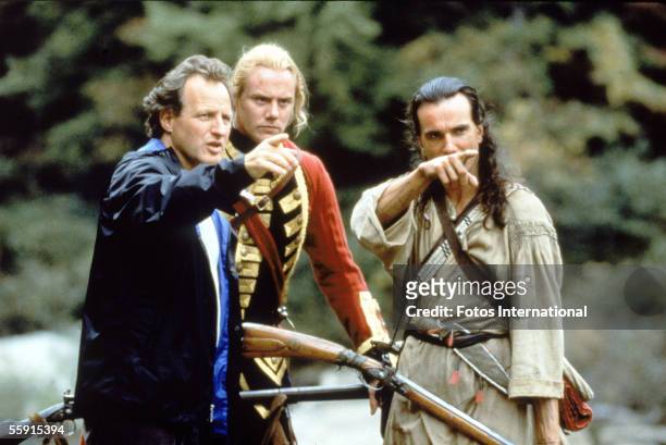 American film director Michael Mann points into the distance as he rehearses a scene with British actors Steven Waddington and Daniel Day-Lewis...