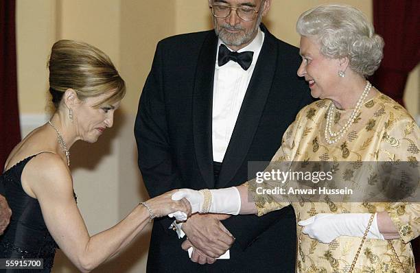 Pop star Madonna shakes hands with Queen Elizabeth II at the World Premiere of the James Bond film 'Die Another Day' at the Royal Albert Hall on...