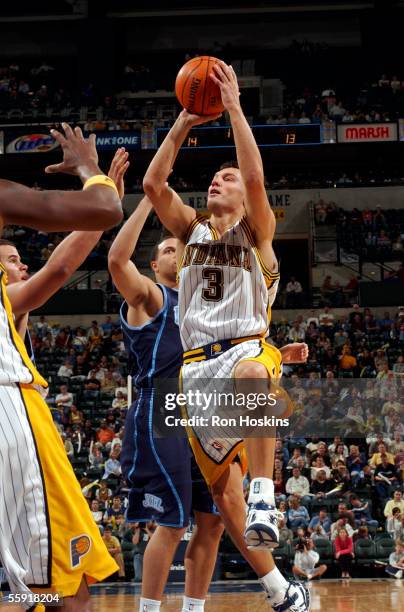 Sarunas Jasikevicius of the Indiana Pacers shoots over Deron Williams of the Utah Jazz on October 13, 2005 at Conseco Fieldhouse in Indianapolis,...