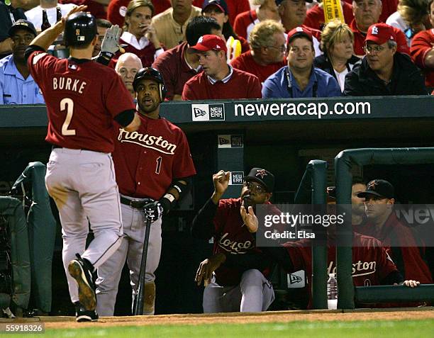 Chris Burke of the Houston Astros is congratulated by Willy Taveras after scoring on a wild pitch in the second inning against the St. Louis...