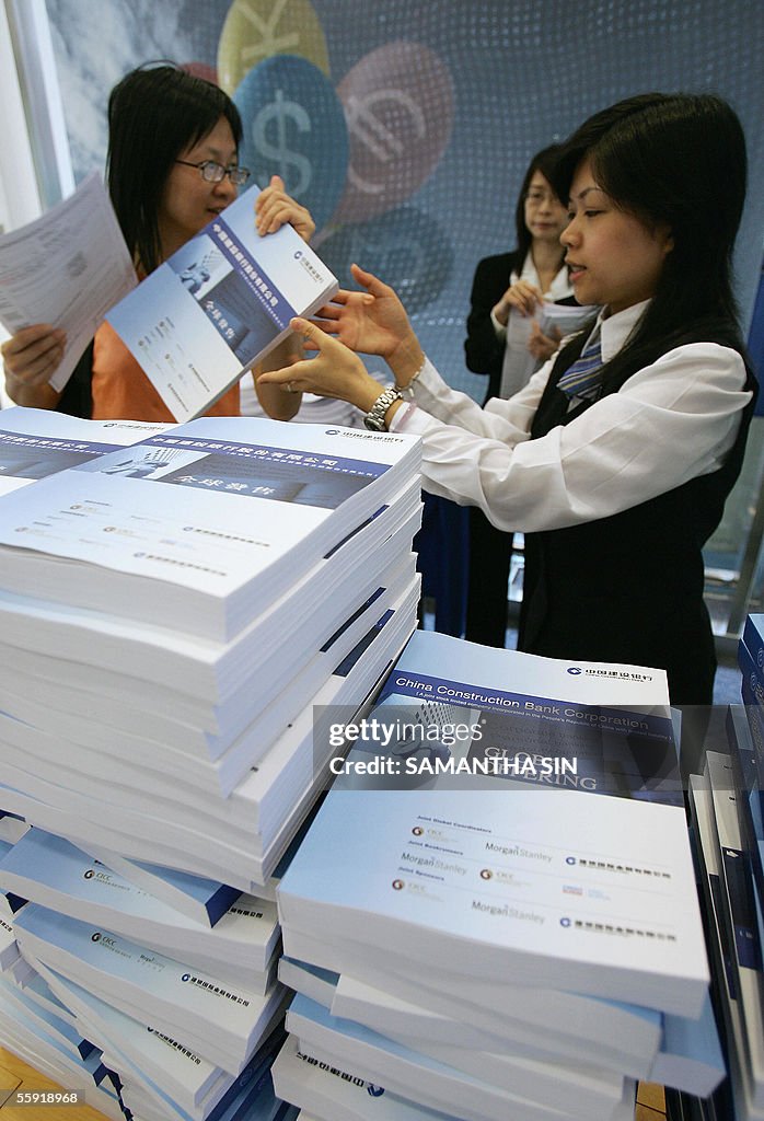 Bank staff distribute copies of the pros