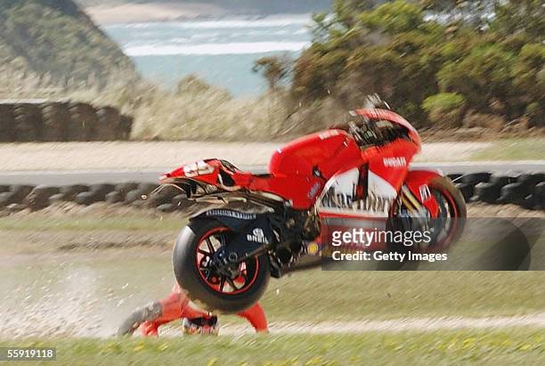 Loris Capirossi of Italy and the Ducati Marlboro Team crashes heavily during practice for the Australian MotoGP at the Phillip Island Circuit on...