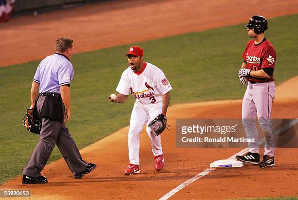 Third baseman Abraham Nunez of the St. Louis Cardinals argues with third base umpire Larry Poncino after missing a tag on a triple by Chris Burke of...