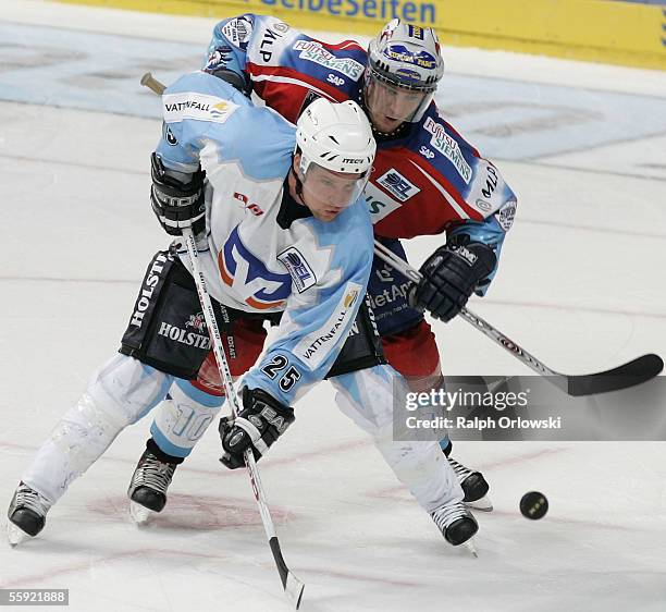 Benoit Gratton of Hamburg Freezers chalenges Lonny Bohonos of Adler Mannheim during their DEL match at the SAP Arena on October 14, 2005 in Mannheim,...