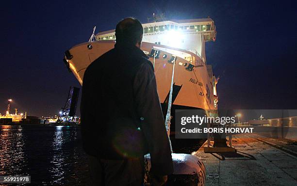Worker is about to throw off the lines of the National Corsica Mediterranean Company ferry Paglia Orba before it leaves the port of Marseille as...