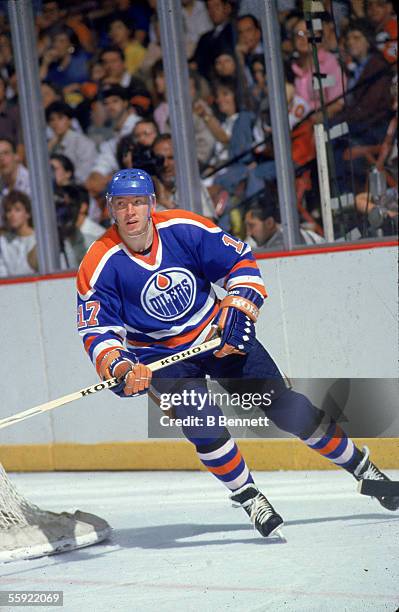Finnish professional hockey player Jari Kurri of the Edmonton Oilers skates around the back of the goal during an away game, 1980s.