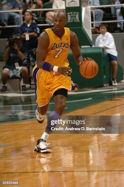 Lamar Odom of the Los Angeles Lakers drives during a preseason game against the Golden State Warriors at Stan Sheriff Center at the University of...