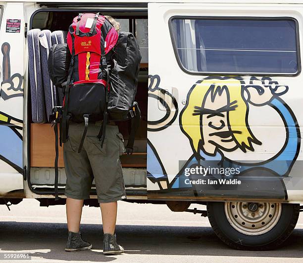 Backpacker Katherine Scheer from Germany loads her backpack into a hired "Wicked" van before setting off for the outback October 14, 2005 in Darwin,...