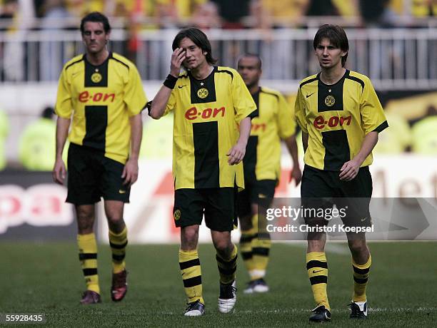 Christoph Metzelder, Tomas Rosicky and Ebi Smolarek of Dortmund leave the ground disappointed after a 3-3 draw during the Bundesliga match between...