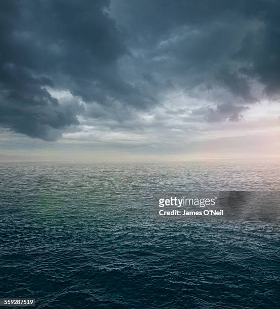 ocean sea with dramatic clouds - sea sky stock-fotos und bilder