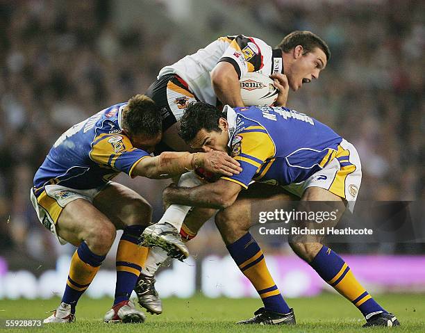 Ben Harris of Bradford is stopped by Kevin Sinfield and Chris McKenna of Leeds during the Engage Super league Grand Final between Leeds Rhinos and...