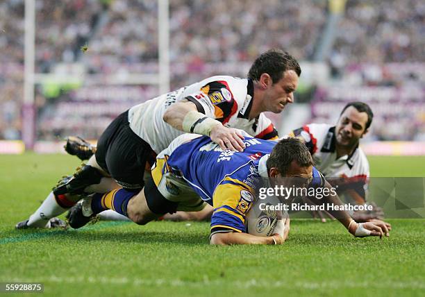 Danny McGuire of Leeds is hauled down just short of the tryline by Bradford's Jamie Peacock during the Engage Super league Grand Final between Leeds...