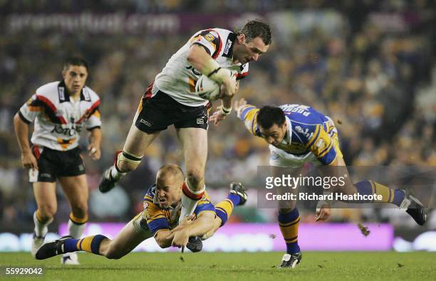 Jamie Peacock of Bradford is tackled by Andrew Dunemann of Leeds during the Engage Super league Grand Final between Leeds Rhinos and Bradford Bulls...