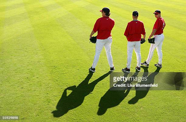 John Lackey, Jarrod Washburn and Robb Quinlan of the Los Angeles Angels of Anaheim talk during warm ups before Game Four of the American League...
