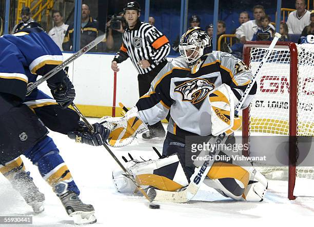 Goalie Tomas Vokoun of the Nashville Predators looks to stop the puck against Keith Tkachuk of the St. Louis Blues at the Savvis Center on October...