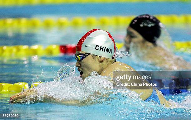 Olympic champion Luo Xuejuan of the Zhejiang Province Swimming Team, competes with Qi Hui of Chinese Army Team during the women's 100 metres...