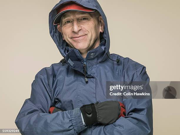 older male in wet weather outdoor clothing - regnkläder bildbanksfoton och bilder