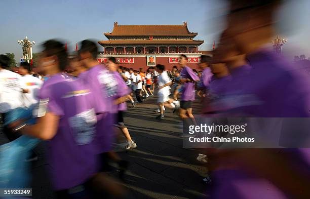 Athletes run past the Tiananmen Gate during the Beijing International Marathon on October 16, 2005 in Beijing, China. The event has attracted 38...