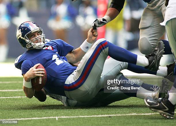 Quarterback Eli Manning of the New York Giants is sacked by DeMarcus Ware of the Dallas Cowboys on October 16, 2005 at Texas Stadium in Irving,...