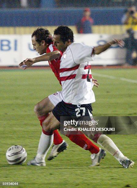 Egyptian player of al-Ahli Club Osama Hosni try to get his way from al-Motaz Bilah player of al-Zamalek club during their match in the semi final in...