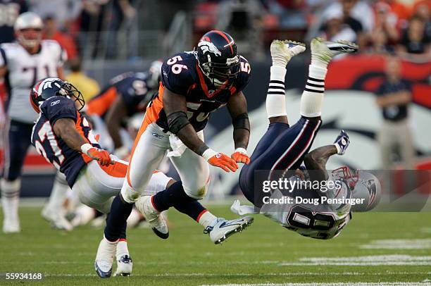 Deion Branch of the New England Patriots is unable to make a pass reception as he is hit and upended by Darrent Williams and Al Wilson of the Denver...