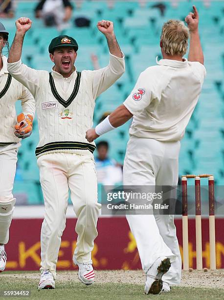Ricky Ponting and Shane Warne of Australia celebrate the wicket of Rahul Dravid of the ICC World XI during day four of the Johnnie Walker Super...