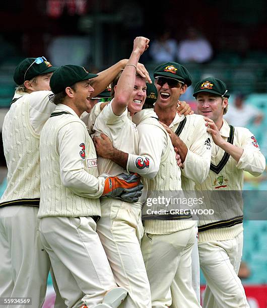 Australian bowler Brett Lee celebrates with teammates after taking the wicket of World XI batsman Inzamam-ul-Haq, LBW for no runs, on day four of the...