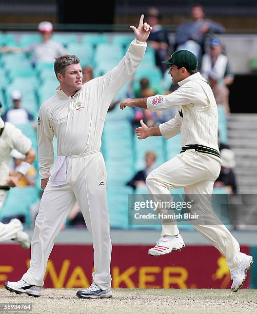 Stuart MacGill and Ricky Ponting of Australia celebrate the wicket of Andrew Flintoff of the ICC World XI during day four of the Johnnie Walker Super...