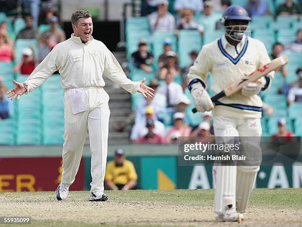 Stuart MacGill of Australia celebrates the final wicket of Muttiah Muralitharan as Australia win the Super Test by 210 runs on day four of the...