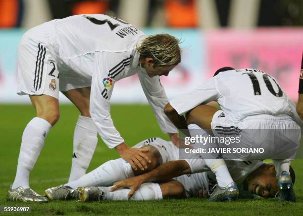 Real Madrid's Brazilian Ronaldo lies injured next to his teammates Robinho and Briton David Beckham during their Spanish league football match...