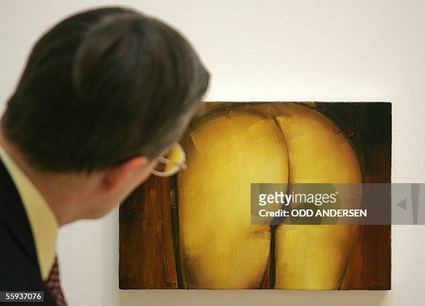 London, UNITED KINGDOM: An art critic iexamines a painting by British artist Gillian Carnegie at the Turner Prize exhibition at the Tate Britain...