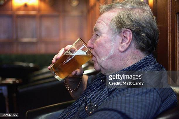 Man enjoys a drink in the Harrington Club, a traditional gentlemans club in Bath on October 15, 2005 in Bath, England, as pubs and clubs prepare for...
