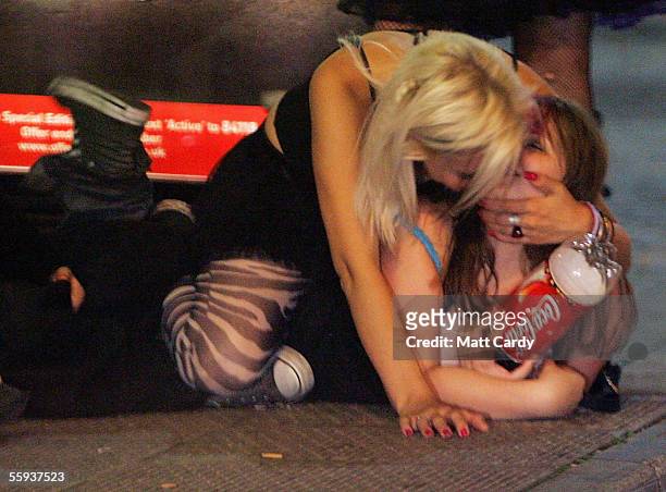 Two girls play around while lying on the floor in Bristol City Centre on October 15, 2005 in Bristol, England. Pubs and clubs are preparing for the...
