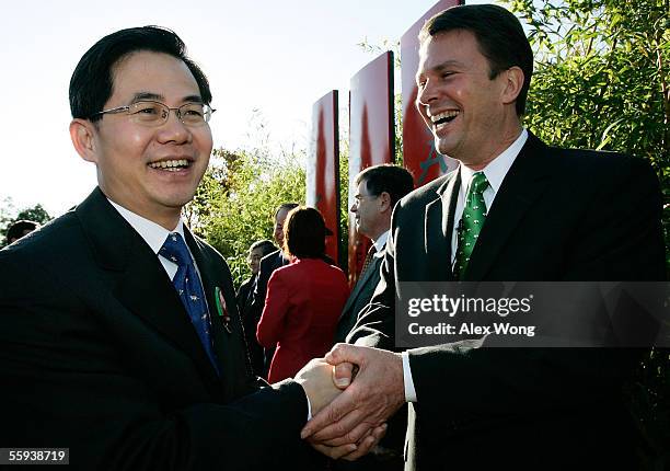 John Berry , the Smithsonian's National Zoo director, shakes hands with Zheng Zeguang , deputy chief of mission of the Chinese Embassy, during a...