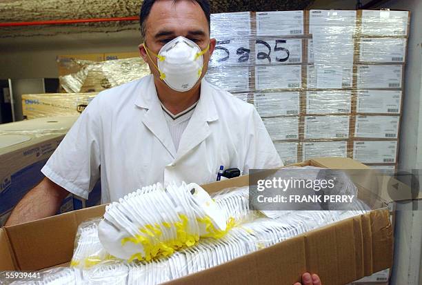 Alain Champain, nurse of the Nantes's hospital, West of France, wears a face mask, 17 October 2005, in the store of the establishment where 48,000...