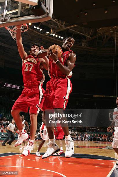 Zaza Pachulia and Joe Johnson of the Atlanta Hawks jump for a rebound ball during the game against the Charlotte Bobcats on October 17, 2005 at the...