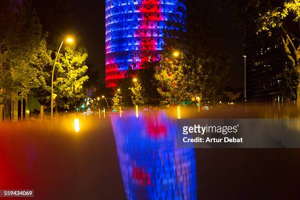 agbar tower illuminated at night with reflection - leuchtgeschoss stock-fotos und bilder