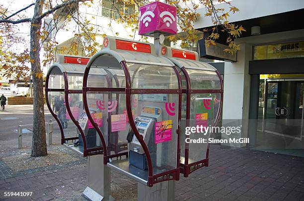 Telstra pay phone kiosks, one set with a pink wi-fi hotspot sign on top on City Walk, Canberra, Australian Capital Territory, Australia