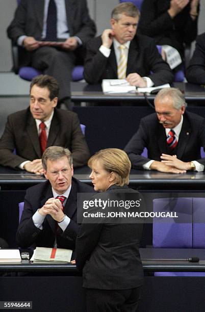 German Chancellor designate Angela Merkel chats with Lower Saxony Premier Christian Wulff during the first sitting of the newly elected lower house...