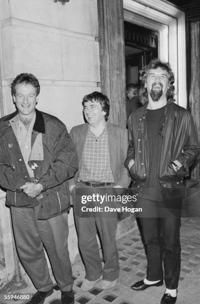 American comedian Robin Williams outside Langan's restaurant, London, with English comedian Dudley Moore and Scottish comic Billy Connolly , circa...