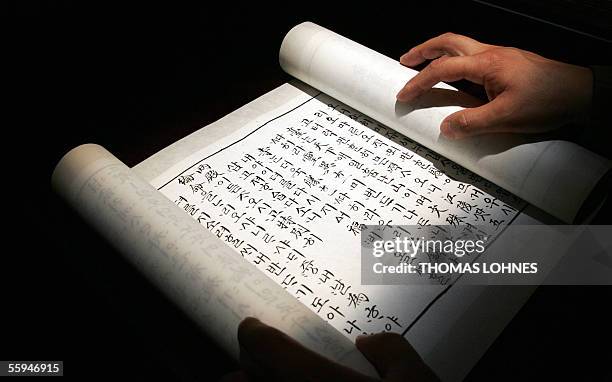 Germany: An assistant of the "Museum for Printing Arts" from Cheongju arranges the most ancient Korean handwritten document, 18 October 2005 at...