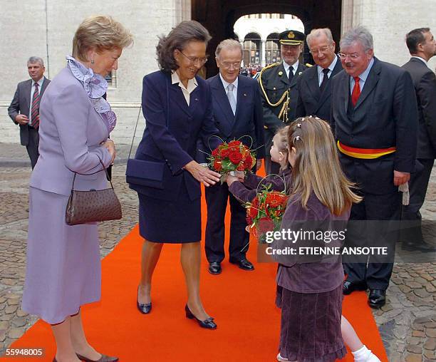 Belgium's Queen Paola and Maria Jose Ritta , wife of Portuguese President Jorge Sampaio, receive flowers next to Brussels' Mayor Freddy Thielemans as...