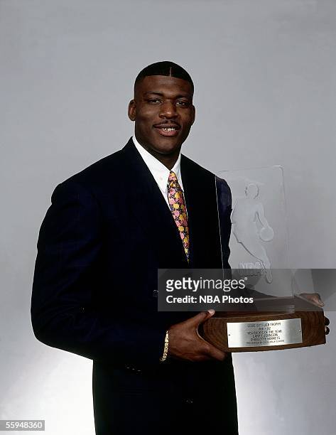 Larry Johnson of the Charlotte Hornets poses for a portrait with his 1991-92 Rookie of the Year award during a portrait session circa 1992. NOTE TO...