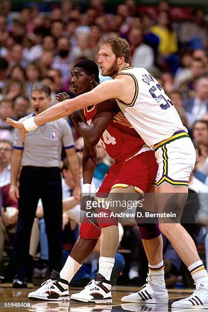 Mark Eaton of the Utah Jazz guards Hakeem Olajuwon of the Houston Rockets in the post during an NBA game circa 1989 in Salt Lake City, Utah. NOTE TO...