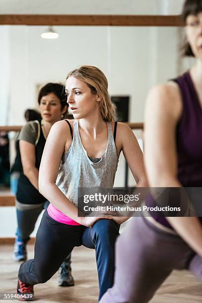 women stretching in workout class - aerobics stock pictures, royalty-free photos & images