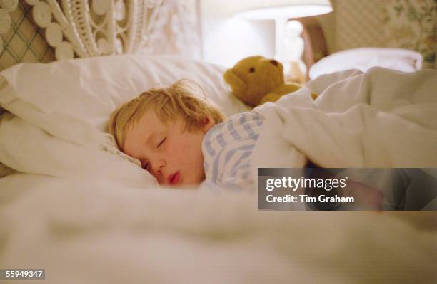 Young boy sleeping in a hotel in Devon, England.