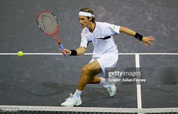 Juan Carlos Ferrero of Spain plays a forehand against Max Mirnyi of Belarus in the first round of the ATP Madrid Masters at the Nuevo Rockodromo...