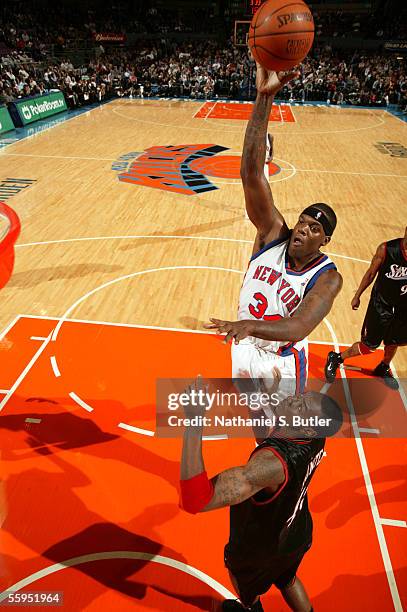 Eddie Curry of the New York Knicks shoots against Steven Hunter of the Philadelphia 76ers on October 18, 2005 at Madison Square Garden in New York...